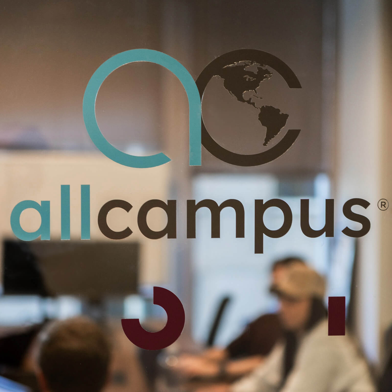 AllCampus logo on a glass door