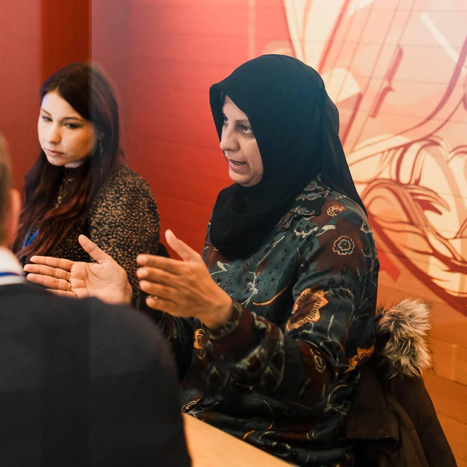 Tashin speaking with a group