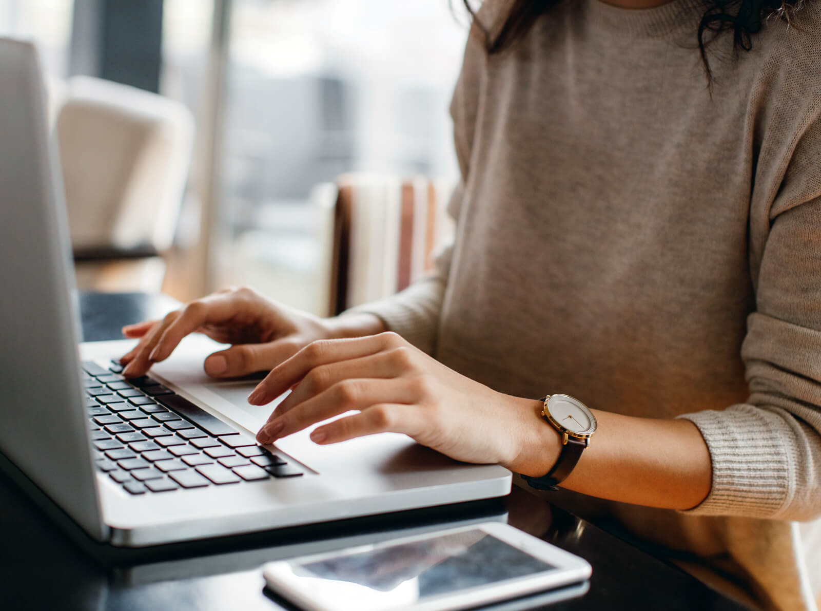 Woman typing on a laptop
