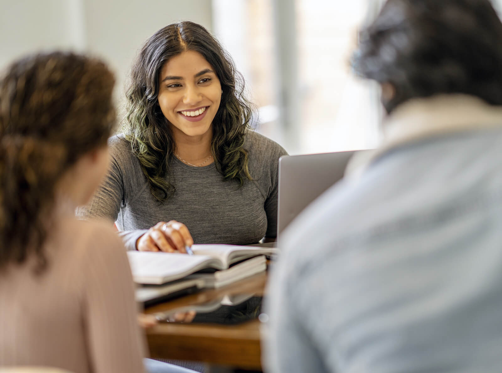 Woman smiling in a group study