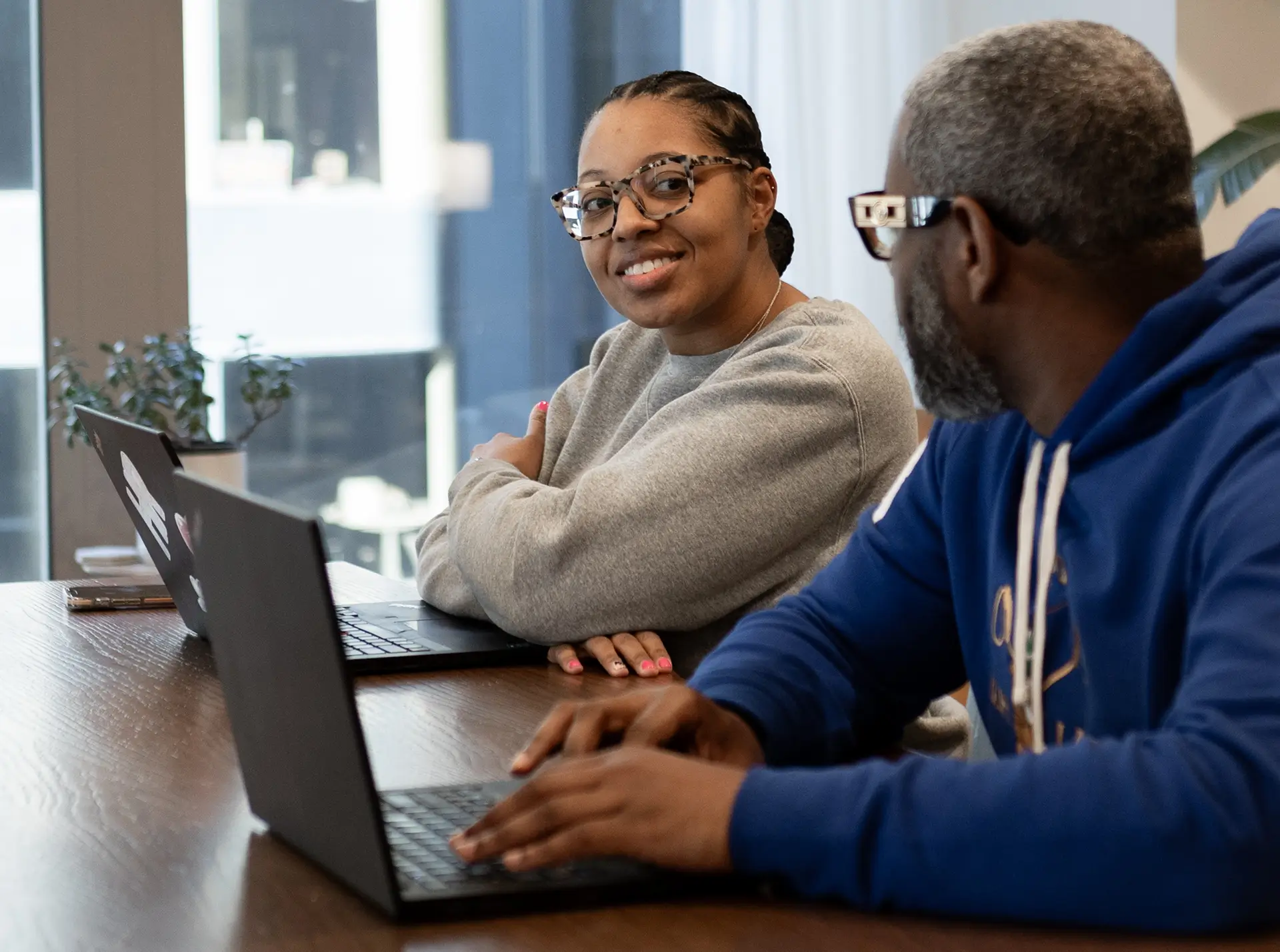 Two students laughing together