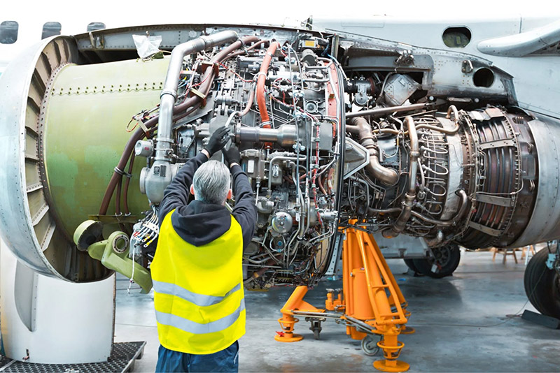 Aviation professional working on an engine